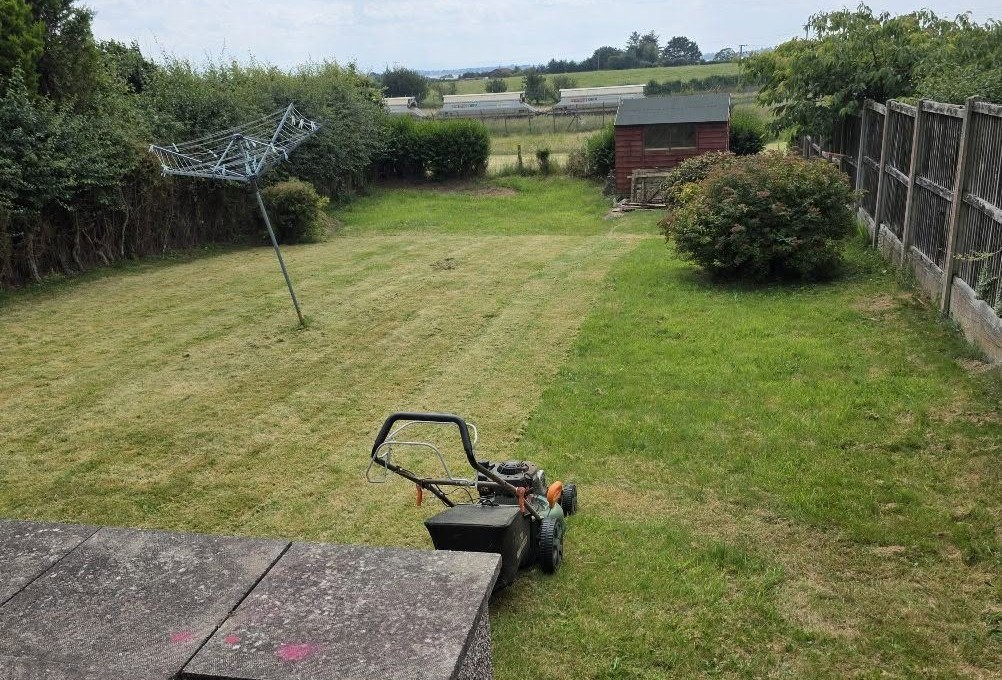 Freshly cut lawn and tidy garden maintained by JD Property Maintenance in Annan